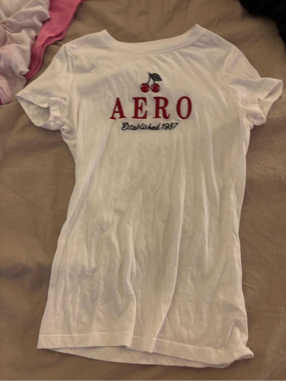 White Aeropostale baby tee with red 'AERO' text and cherries